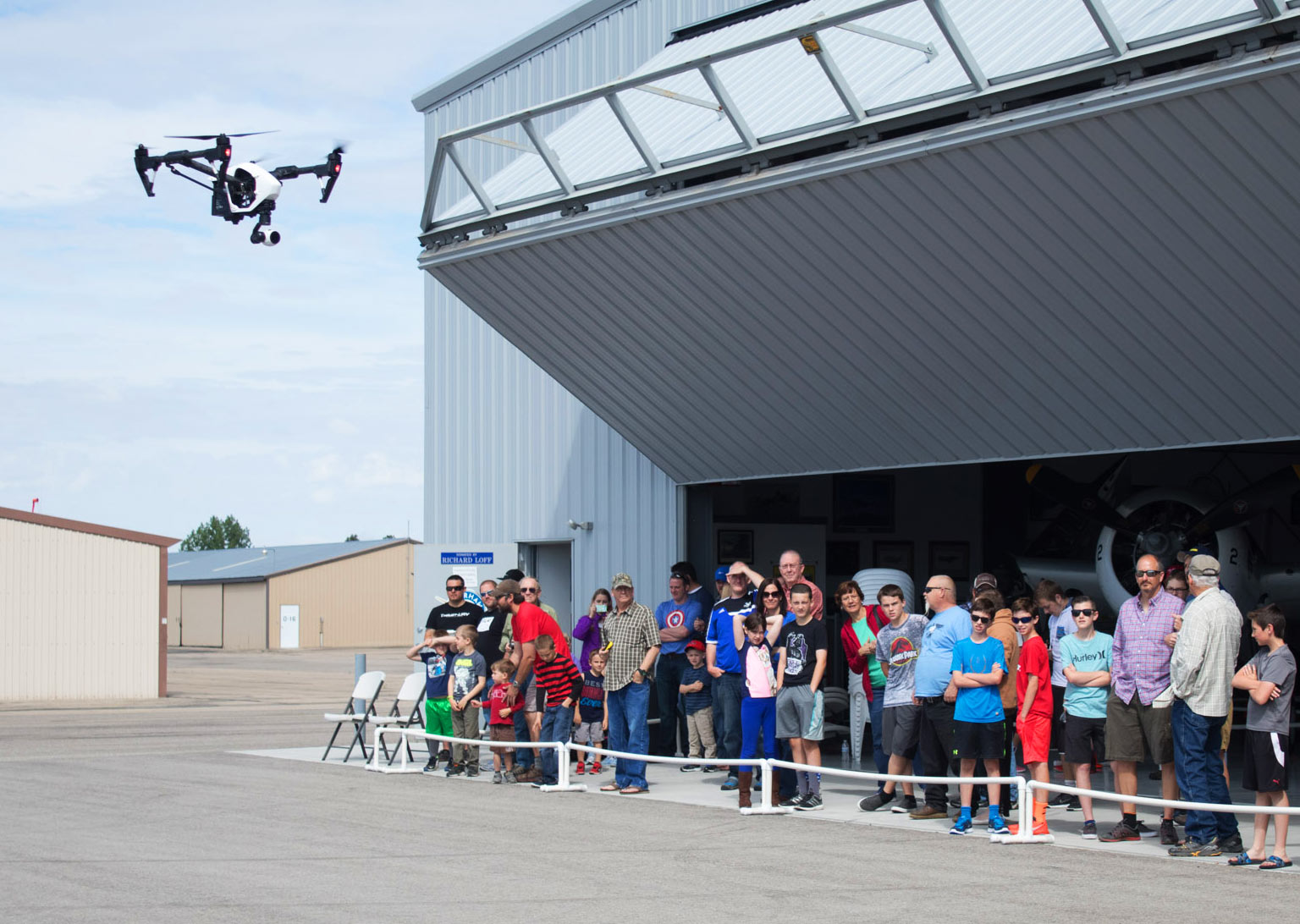 Kids and Adults watching a drone fly by at Warhawk Drone Days