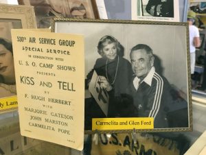 Warhawk Air Museum display including image of Carmelita Pope and Glen Ford and a program for the play 'Kiss and Tell'