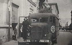 Carmelita Pope next to the troupe's transport bus