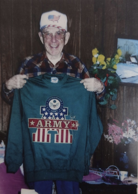 Sam holding an Army sweatshirt